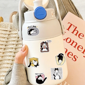 Cute black and white cow cat stickers applied on a white water bottle in a cozy setting