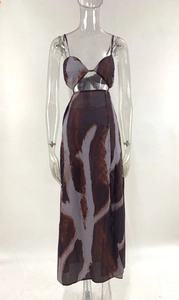Detail of a tie-dye maxi dress featuring deep brown marble print and waist cut-out