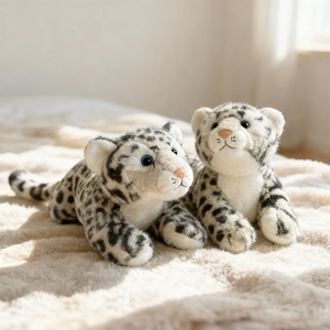 Plush snow leopard stuffed animals with realistic spots on soft white carpet