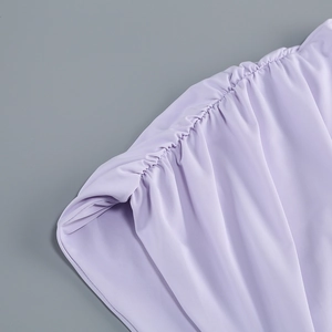 Detailed view of the lavender gathered fabric with elegant ruched texture and silky finish