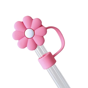 Pink daisy silicone straw topper protector cap for Stanley cups on white background