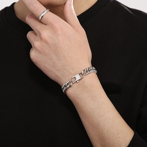 Minimalist silver Cuban link bracelet with rectangle buckle shown on a male wrist