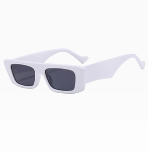 Detail view of stylish white rectangular sunglasses with thick temples and dark lenses
