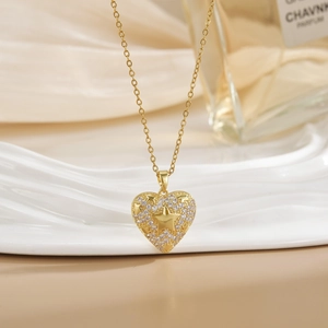 18k gold plated heart necklace with star pattern and crystals on elegant silk background