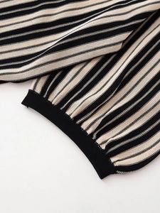 Close-up of high-quality striped knit texture with ribbed cuffs on linen-style loungewear set