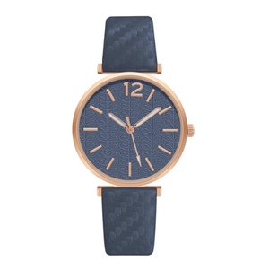 Detailed view of women's watch with navy blue strap and rose gold textured leaf dial
