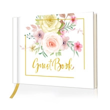 Detail of floral wedding guest book with gold foil lettering and satin ribbon bookmark