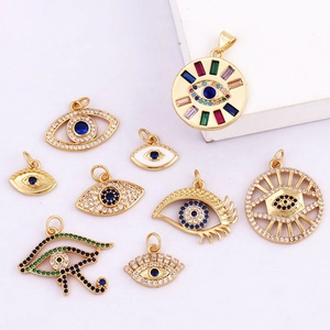 Set of nine assorted gold evil eye charms with colorful zircon and enamel details
