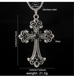 Macro detail of alloy cross pendant with black stones and stainless steel chain