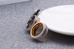 Three-color fluted bezel stainless steel rings with zircon settings on white tray