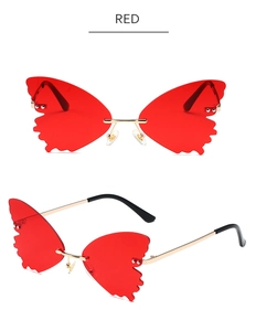 Detail view showing butterfly rimless sunglasses with red gradient lenses and gold metal frame