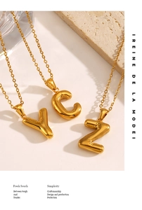 Detailed close-up of golden balloon-style alphabet pendants C, Y, Z with mirror finish