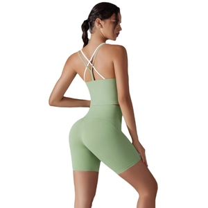 Women's light green yoga set with cross-strap sports bra and high-waisted shorts