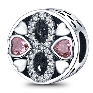 Detailed view of silver heart charm with pink stones, infinity and clover patterns