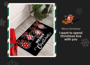 Detail of Christmas doormat with red ornaments and white Merry Christmas text on black