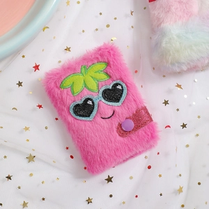 Detail view of pink plush unicorn notebook with snap closure and embroidered cute face