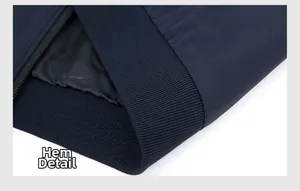 Detail view of the navy blue jacket hem with ribbed knit cuff and premium zipper finish