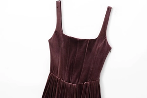 Detailed close-up of dark purple velvet corset dress with square neck and boning seams