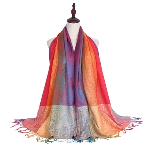 Close-up of bohemian pashmina scarf with colorful gradient paisley patterns and tassels
