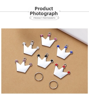 Detail view of six shiny zinc alloy crown charms with colorful inlaid rhinestones