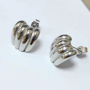 Polished silver croissant style stainless steel hoop earrings with ribbed texture design
