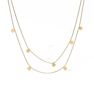 Close-up of a double-layered 18K gold-plated snake chain necklace with round disk pendants