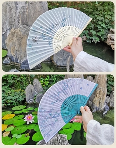 Detail of vintage Chinese folding fans with floral patterns and delicate silk tassels