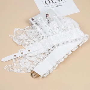 Detailed macro view of white floral lace corset belt with silver buckle and eyelets