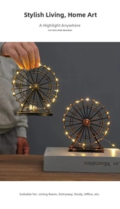 Detail of vintage iron ferris wheel model with warm LED lighting and antique bronze finish