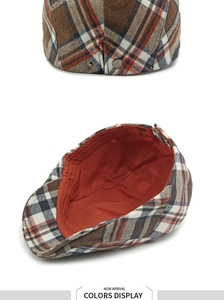 Detail of vintage plaid beret with dual silver snap buttons and orange satin lining