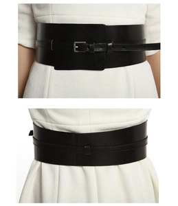 Front and back detail of a wide black leather corset belt with metal buckle on a white dress
