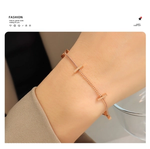 Close-up of rose gold minimalist bar link bracelet worn on a woman's wrist