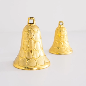 Golden Christmas bells with embossed circular texture and top hanging loops on white background