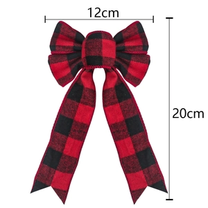 Detail view of red and black plaid Christmas bow showing 12cm by 20cm size measurements
