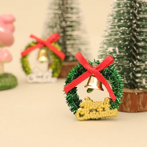 Miniature dollhouse Christmas wreath with golden Merry Christmas sign and red bow