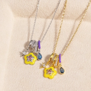 Detail showing gold and silver enamel necklaces with colorful zircon flower pendants