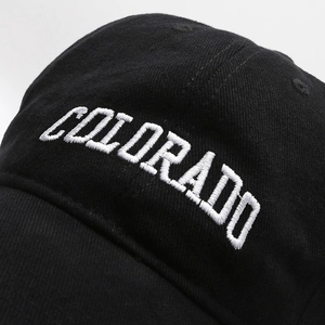 Retro black cotton baseball cap with white Colorado embroidery in a close-up profile view