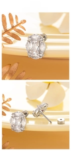 Detailed view of titanium steel stud earrings with rectangular and marquise cut zircons