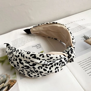 Close-up of leopard print fabric headband with top knot detail on an open magazine