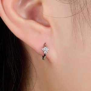 S925 Sterling silver star huggie earrings with cubic zirconia stones on female model