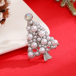 Detail of silver Christmas tree brooch featuring elegant white pearls and a crystal star
