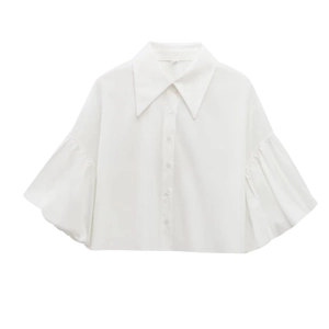 Close-up of a white button-up shirt featuring a large pointed collar and puff sleeves