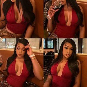 Deep red halter neck top with plunging V-neckline shown in a stylish bar setting