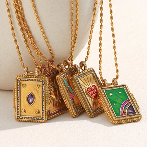 Detailed close-up of 18K gold plated rectangular pendants with enamel and gemstones