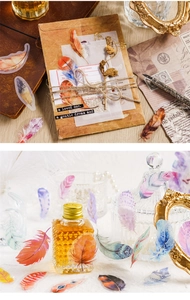 Macro view of vintage feather PET stickers for scrapbooking and artistic journal decoration
