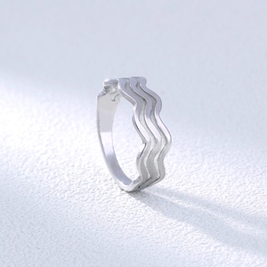 Detailed view of wave-shaped 304 stainless steel ring with polished silver texture