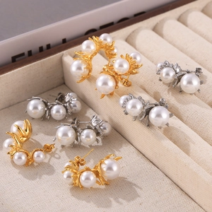 Elegant gold and silver C-shaped titanium earrings with cluster of pearls