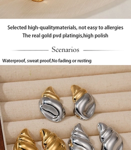 Detail of seashell stud earrings with PVD gold and silver finish on velvet