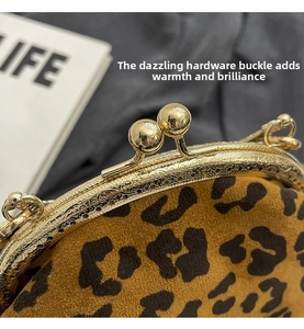 Close-up of leopard print bag with vintage gold clasp and embossed metal frame
