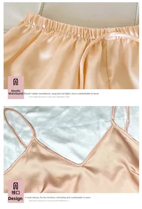 Detail of silk satin pajamas set featuring V-neckline and elastic waistband in peach